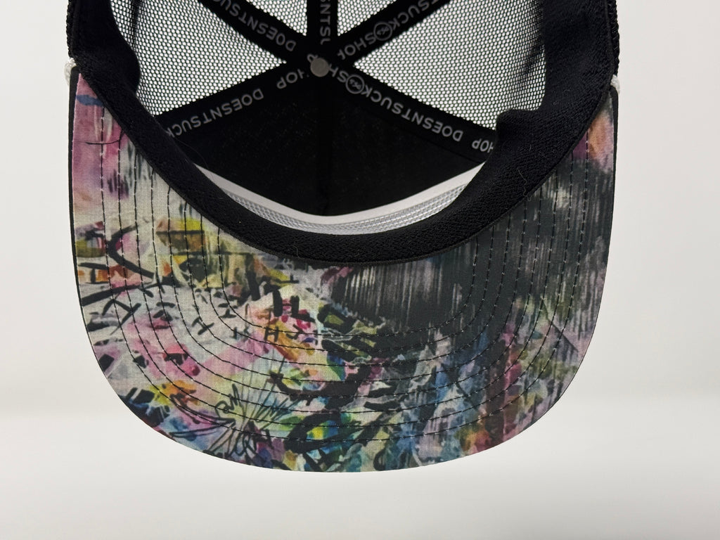 Colorful tie-dye cap with black mesh back on a white background