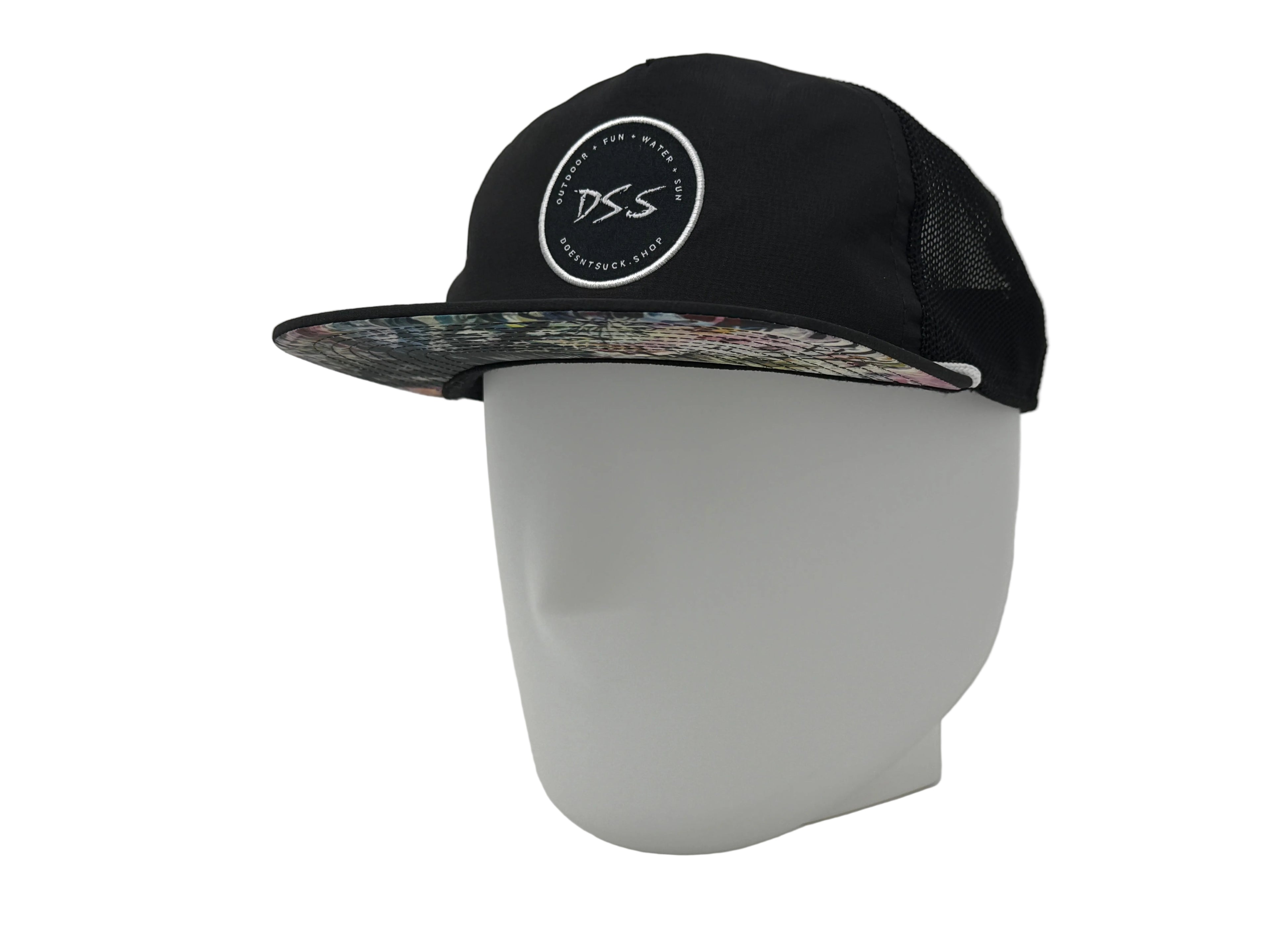 Black cap with floral brim and 'DS.S' logo on a white mannequin head against a white background