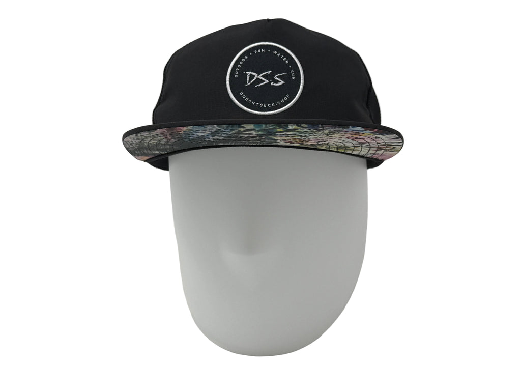 Black cap with floral rim on a mannequin head against a white background