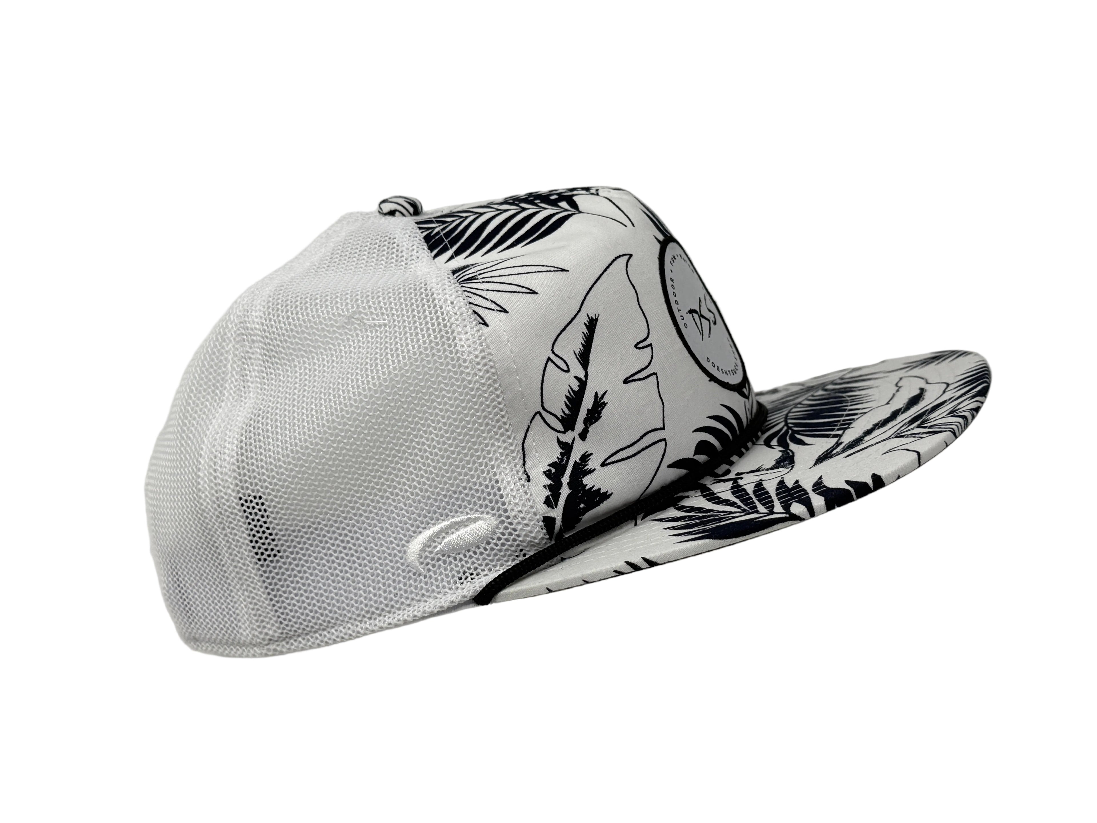 White cowboy hat with black floral patterns on a gray background