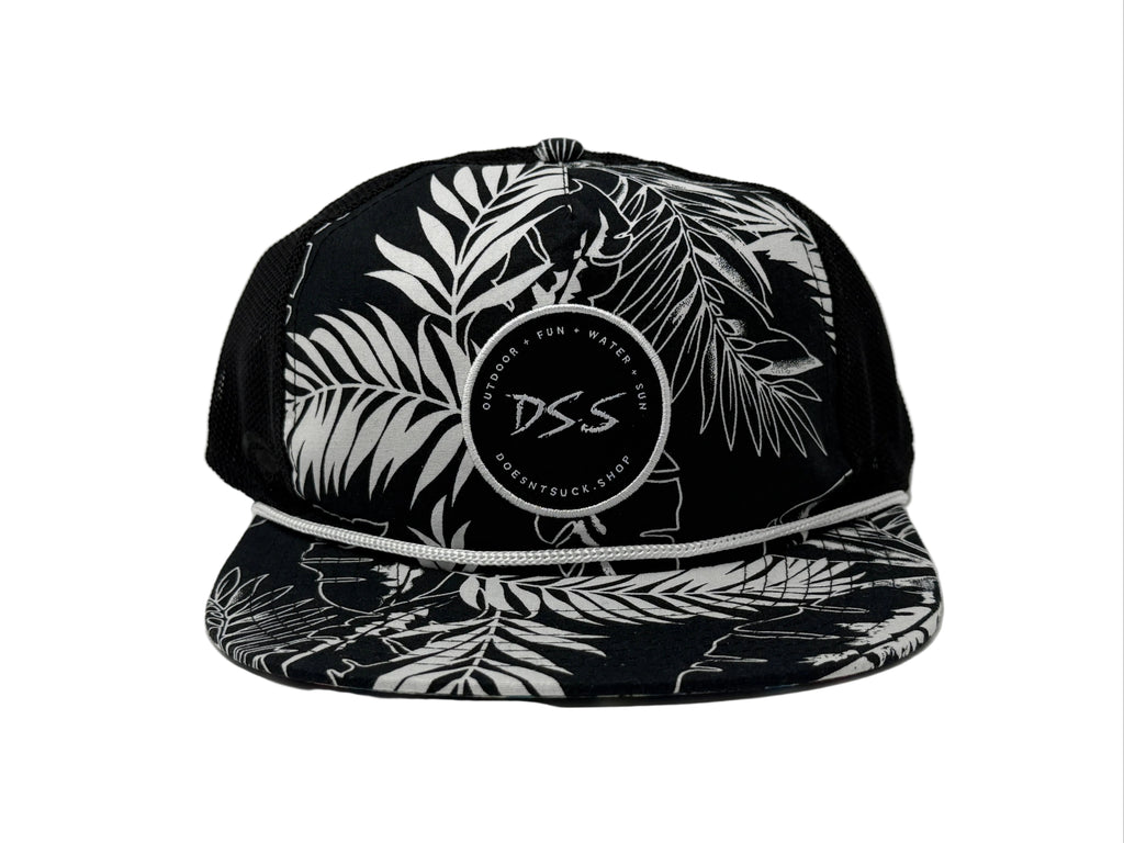 Black cap with white leaf pattern and 'DS.S' logo on a light gray background