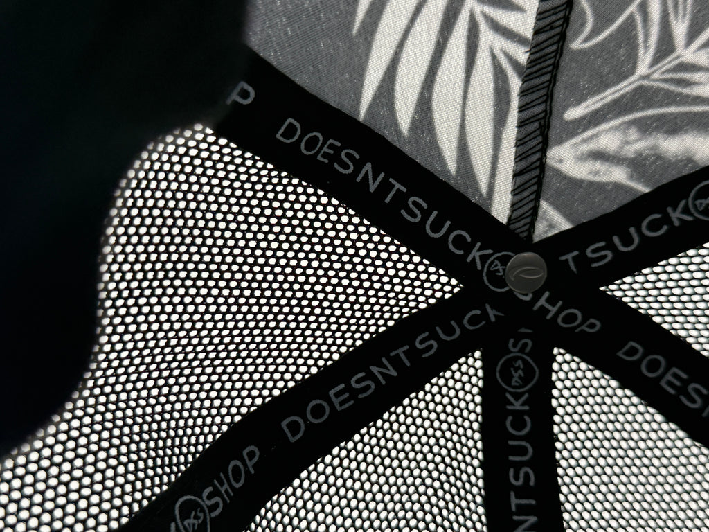 Close-up of a textured surface with 'DOESNTSUCK' branding.