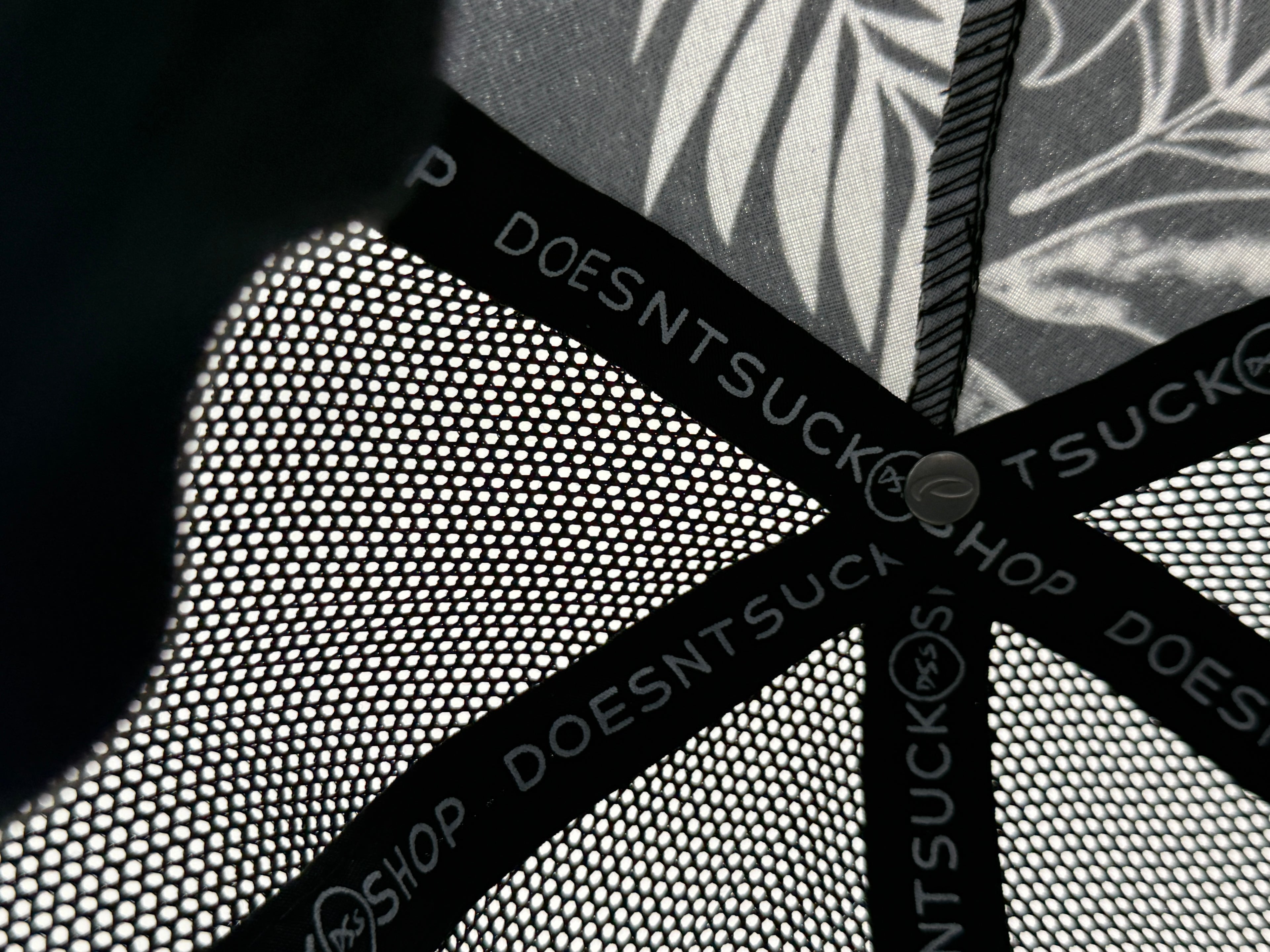 Close-up of a textured surface with 'DOESNTSUCK' branding.