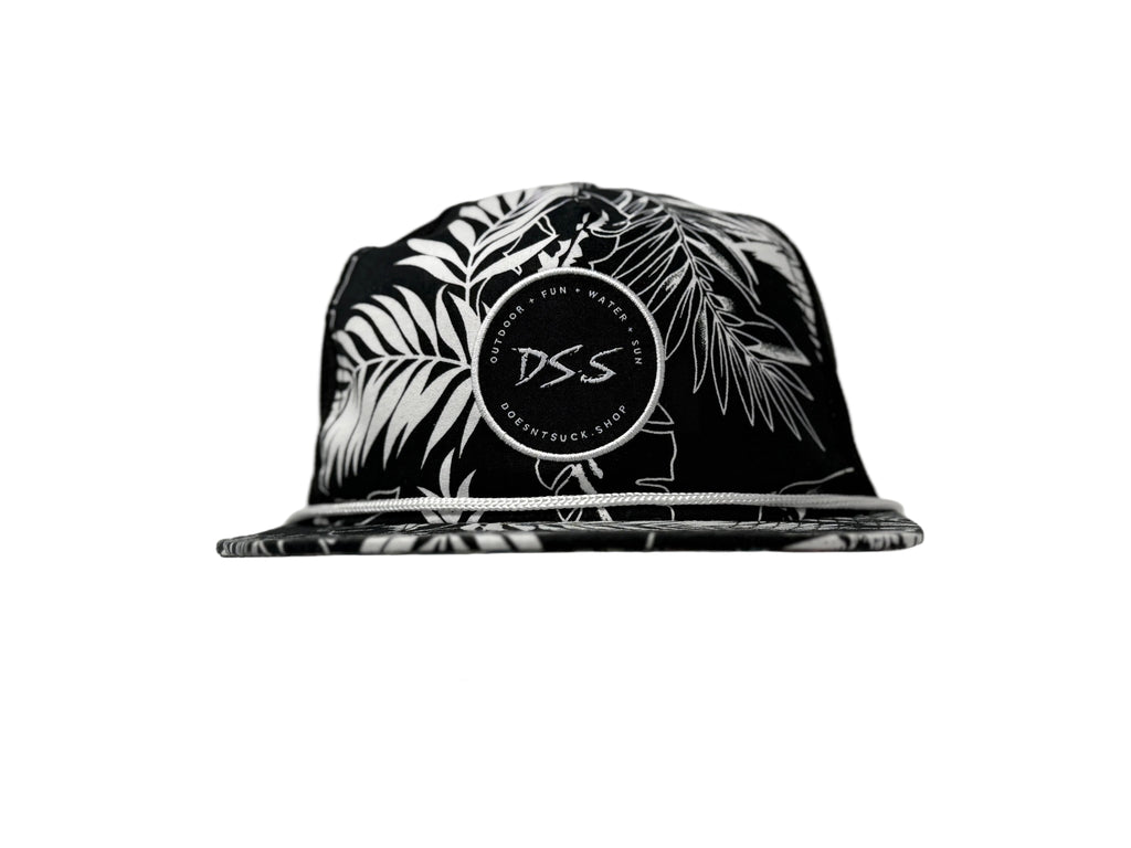 Black and white cap with palm leaf design and 'DS.S' logo on a light gray background
