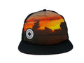 Trucker hat with sunset design and logo on a white background