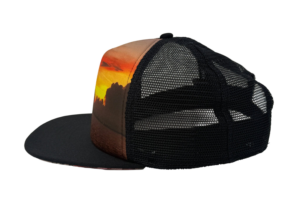 Black mesh cap with a sunset design on the front panel against a white background