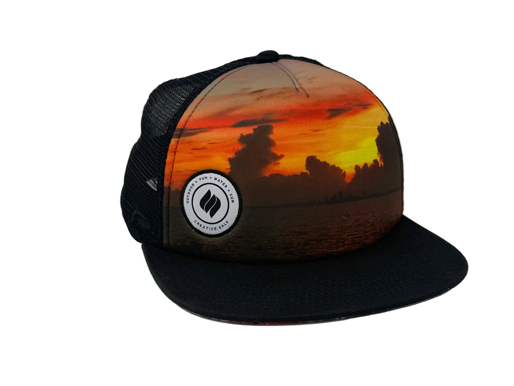 Trucker hat with sunset design and C.S logo on a white background