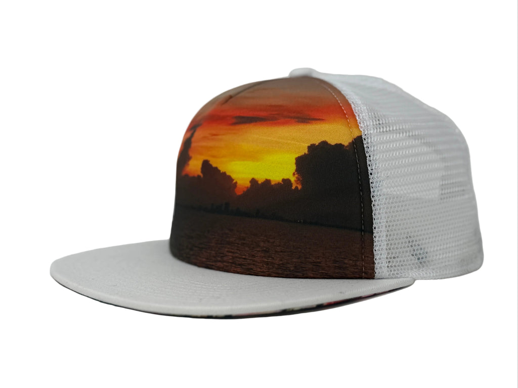 Trucker hat with a sunset design on a white background