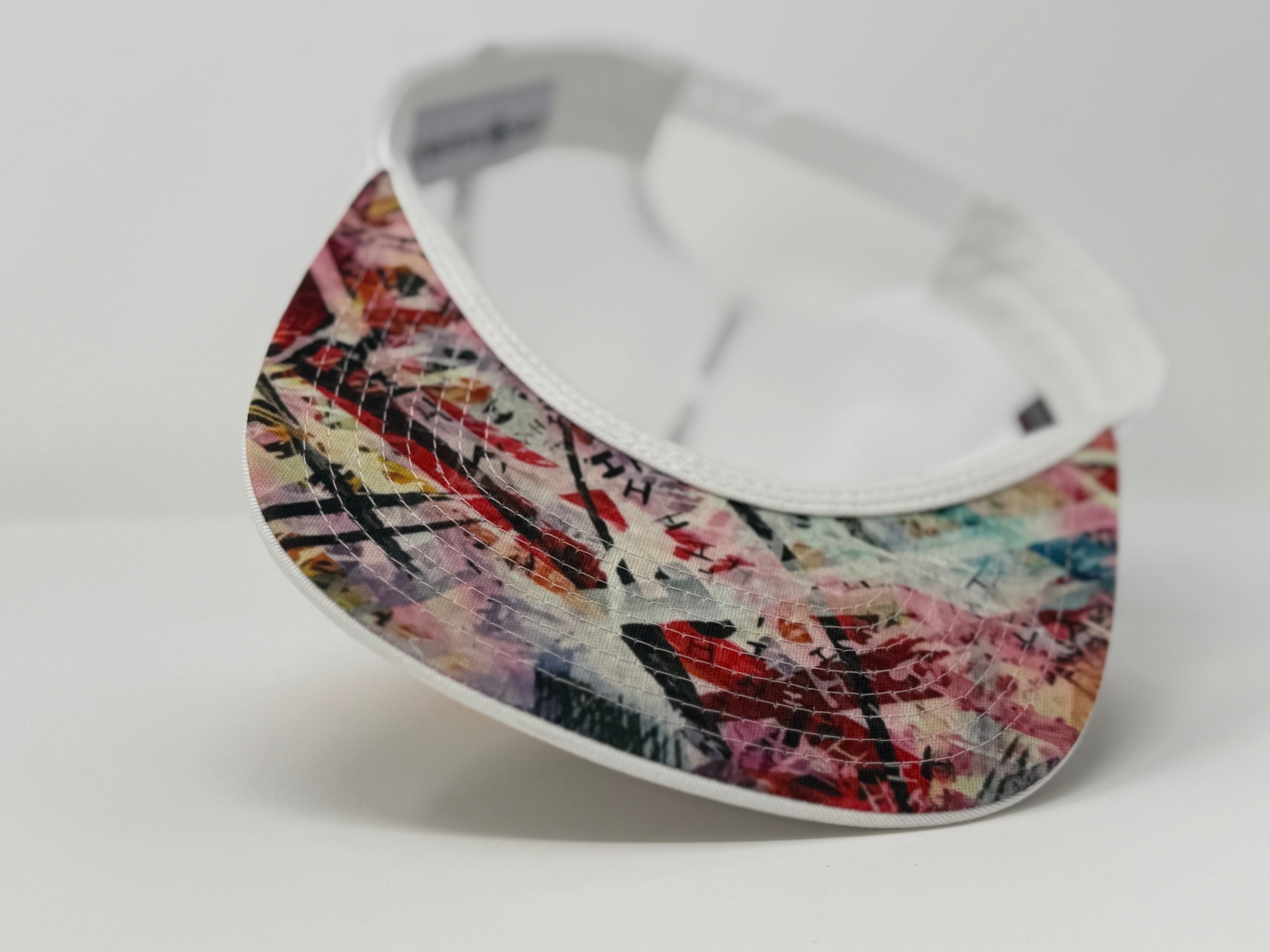 Colorful visor with abstract pattern on a white background