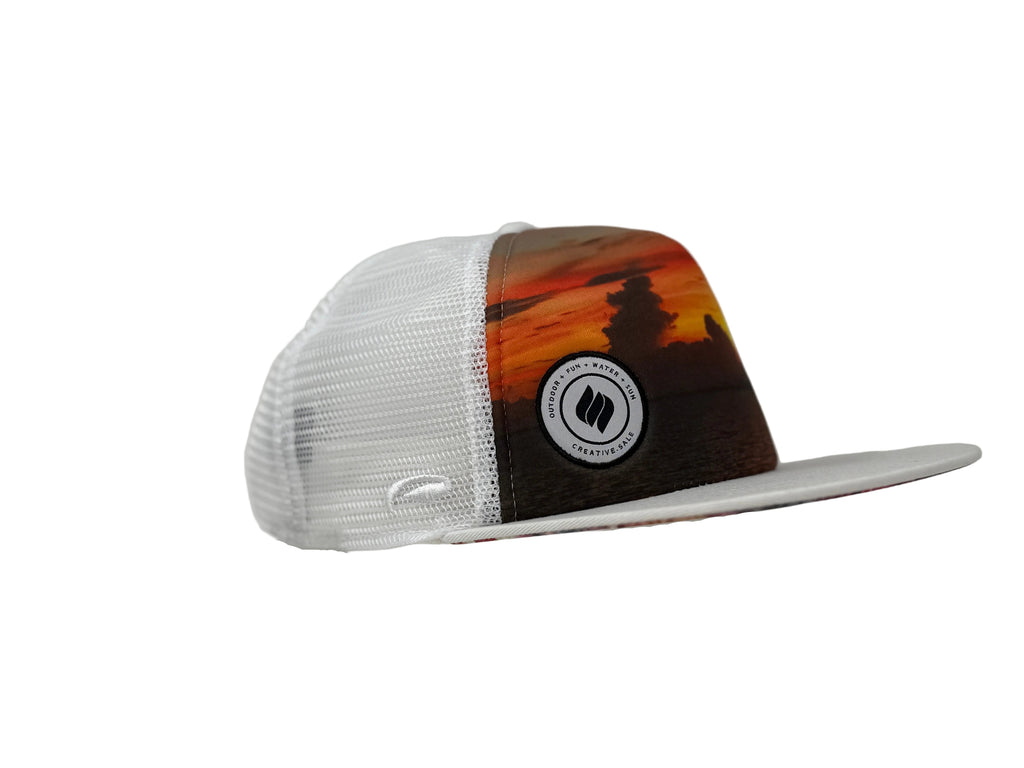 Trucker hat with a sunset design and logo on a gray background