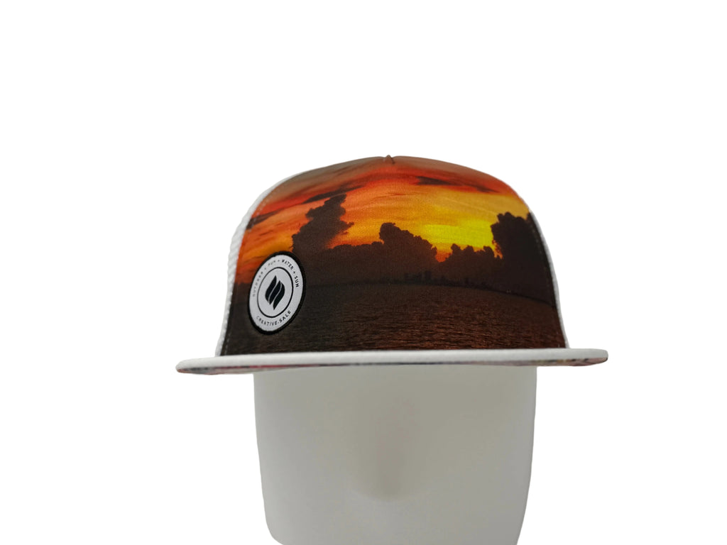Cap with a sunset design and logo on a white background