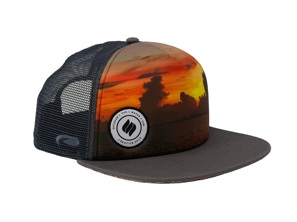 Charcoal Trucker hat with sunset design and logo on a white background