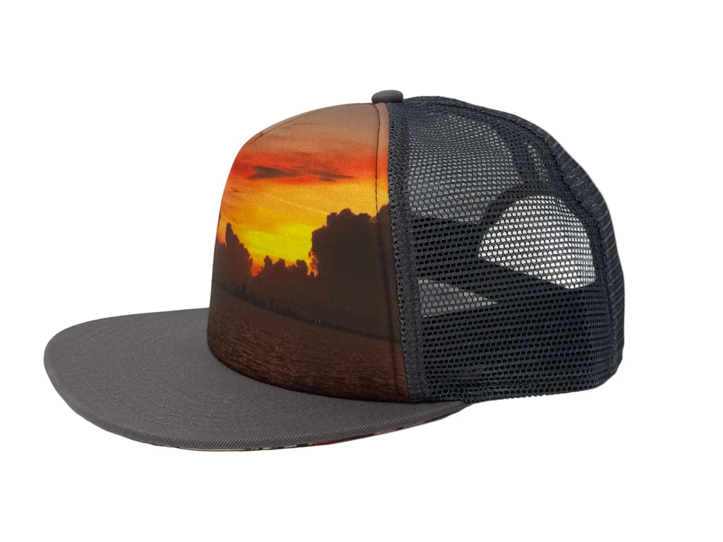 Charcoal Trucker hat with sunset design on a white background