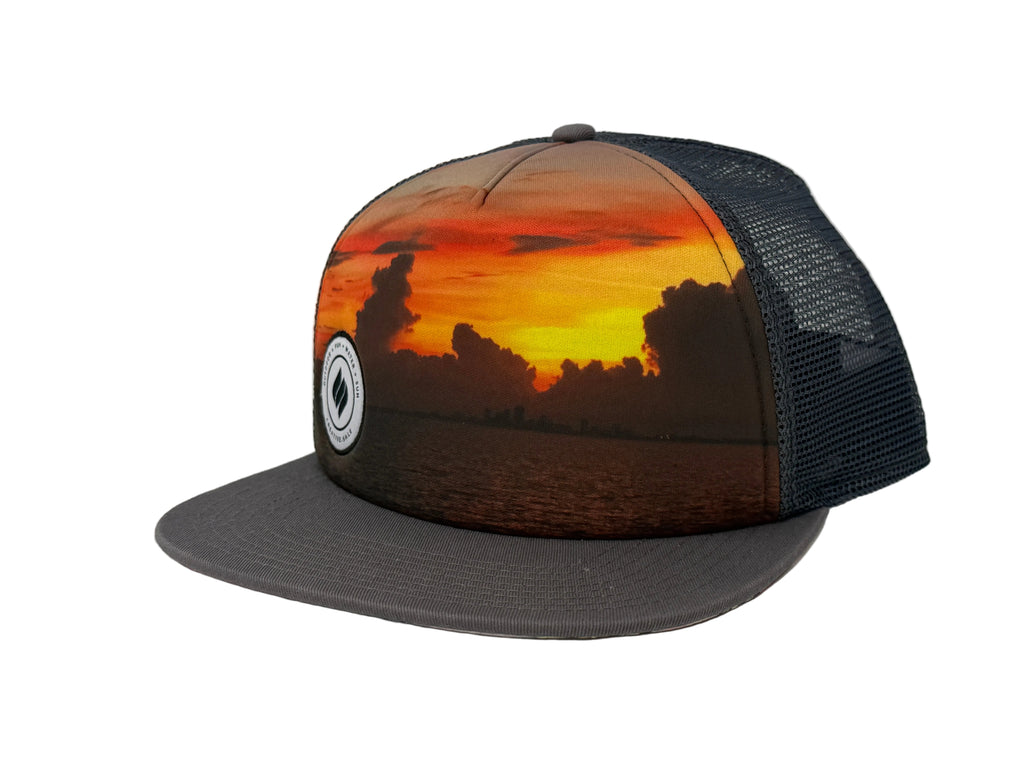 Charcoal Trucker hat with sunset design and black mesh back on a white background