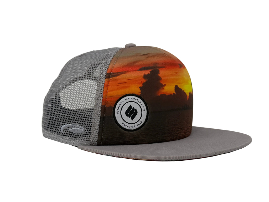 Trucker hat with sunset design and logo on a white background