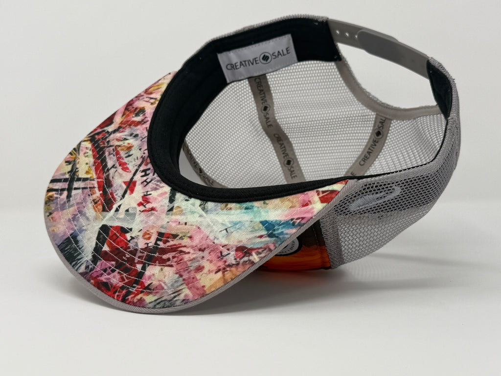 Colorful patterned cap with a gray mesh back on a light gray background