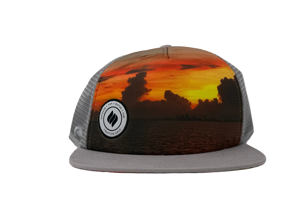 Trucker hat with sunset design and brand logo on a white background
