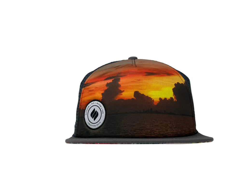 Charcoal Trucker hat with sunset design and logo on a white background