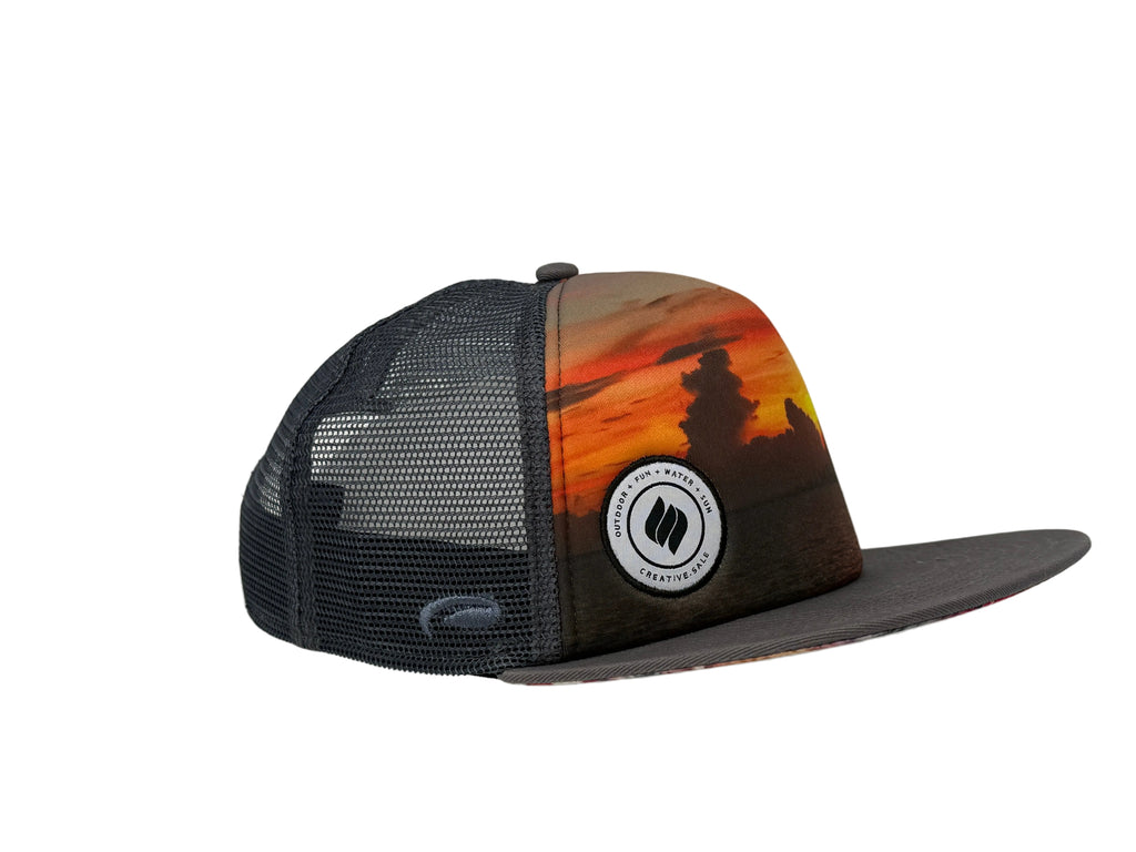 Trucker hat with sunset design and logo on a white background
