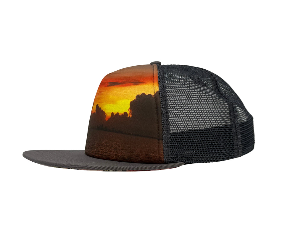 Charcoal Trucker hat with sunset design on a white background